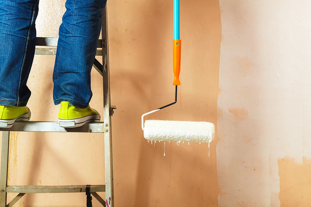 painter painting walls white house.webp