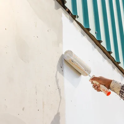 white color painting wall with roller hand.webp